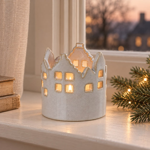 Round Ceramic House Tealight Candle Holder, ceramic house holder glowing beside a window at dusk