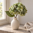 Artificial Short Sage Green Hydrangea Stem, sage green flower head and leaves in a cream vase