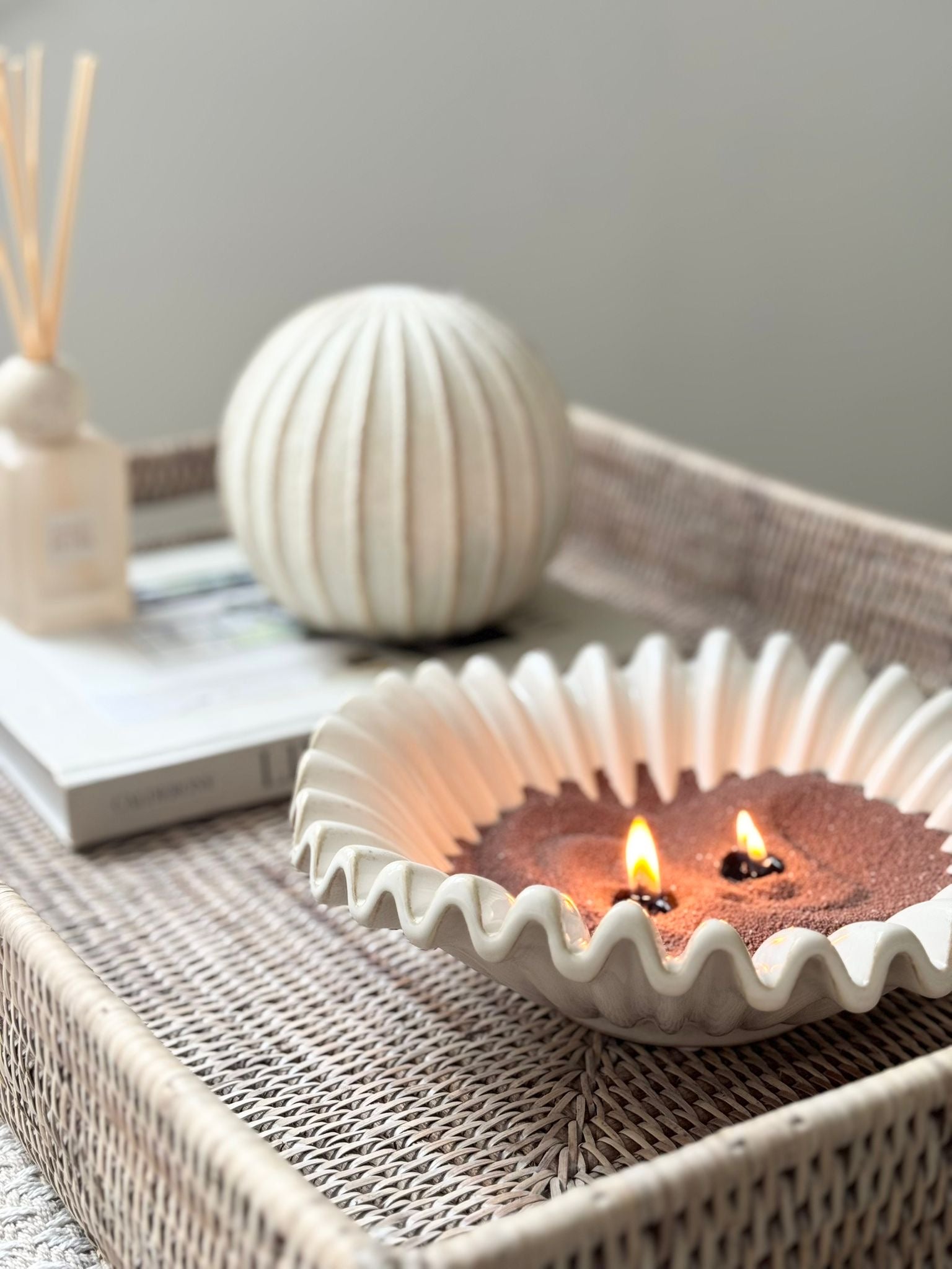 Decorative striped globe ball for home décor by Hill Interiors, featuring colorful patterns and a smooth, round shape.