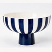 Deep blue and white striped ceramic bowl with a blue pedestal foot on a white background