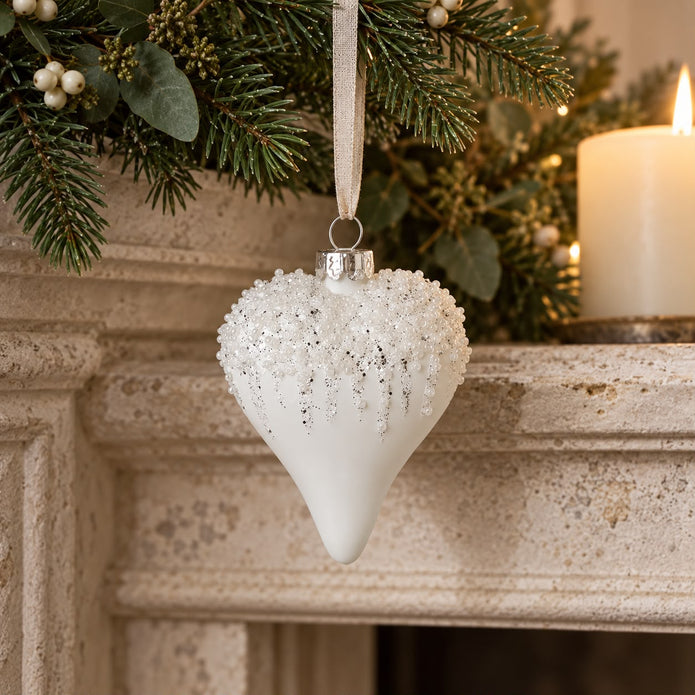 White Bead Top Glass Heart Bauble, white heart bauble hanging beside a mantel candle