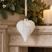 White Bead Top Glass Heart Bauble, white heart bauble hanging beside a mantel candle
