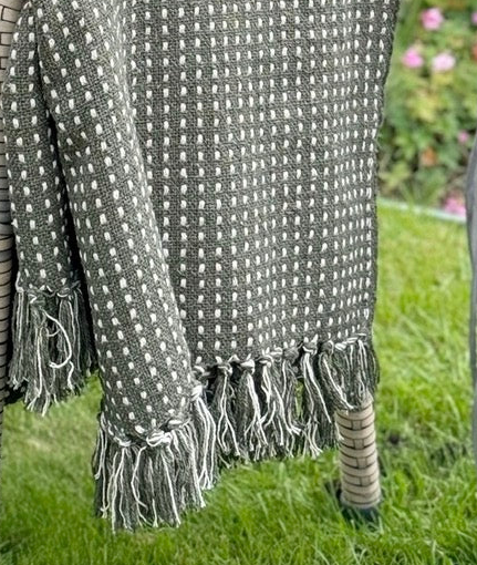 Olive green cotton throw blanket with stab stitch pattern by Gisela Graham, soft furnishings for cozy home decor.