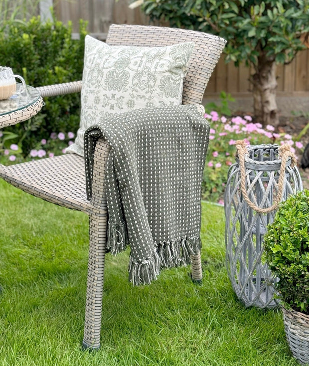 Olive green cotton throw blanket with stab stitch design from Gisela Graham, soft furnishings for cozy home decor.