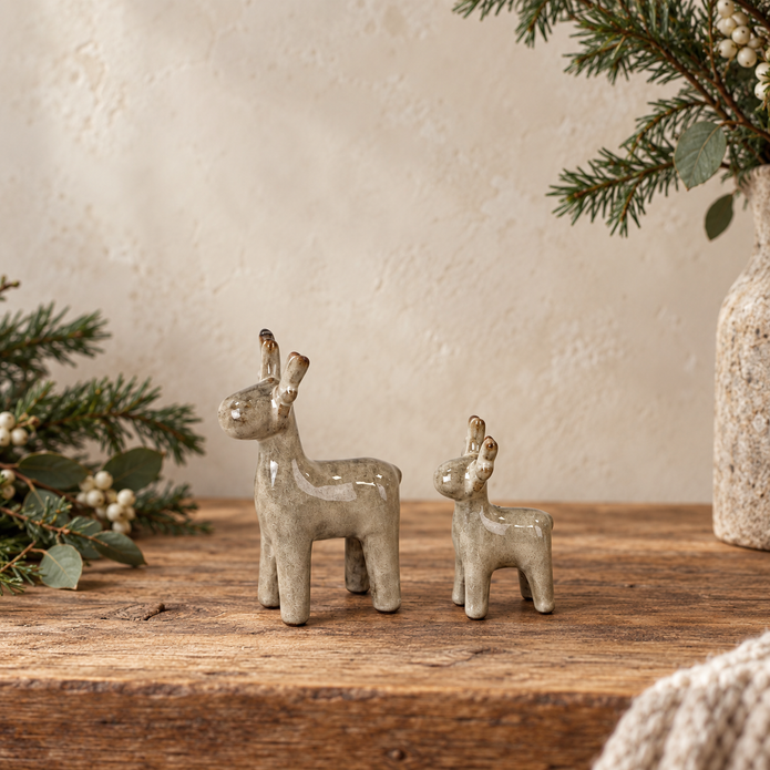 Beige mottled ceramic reindeer decorations in Small and Medium sizes styled side by side