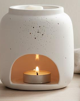 White Ceramic Loire Wax Melt & Oil Burner, close-up of the white speckled burner and glowing tealight