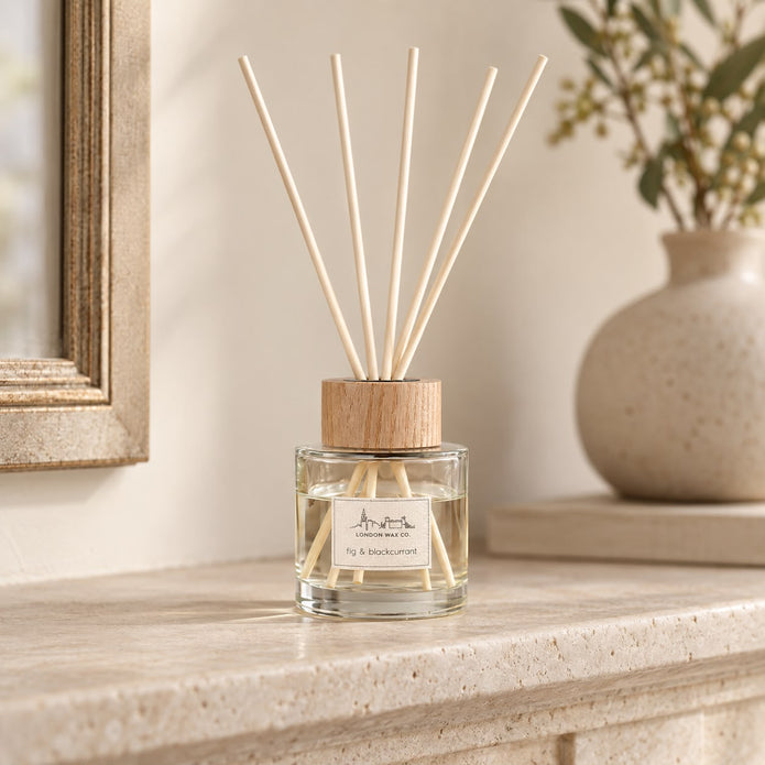 London Wax Company Reed Diffuser with Fig and Blackcurrant scent, featuring elegant glass bottle and natural reed sticks for home fragrance.
