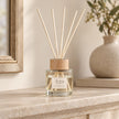 London Wax Company Reed Diffuser with Fig and Blackcurrant scent, featuring elegant glass bottle and natural reed sticks for home fragrance.