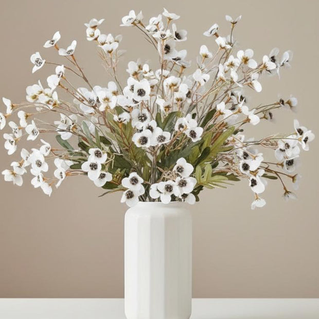 White artificial daisy flower stem from Starlight Express, showcasing realistic white petals and green leaf details.