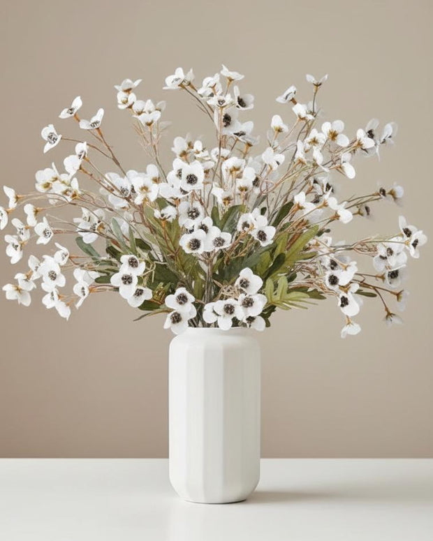White artificial daisy flower stem from Starlight Express, showcasing realistic white petals and green leaf details.