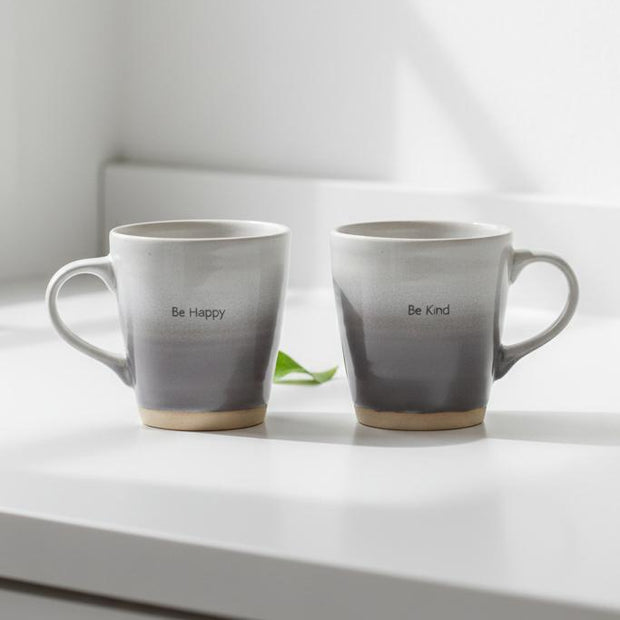 Beige Neutral Stoneware Mug, two grey and white stoneware mugs on a kitchen counter