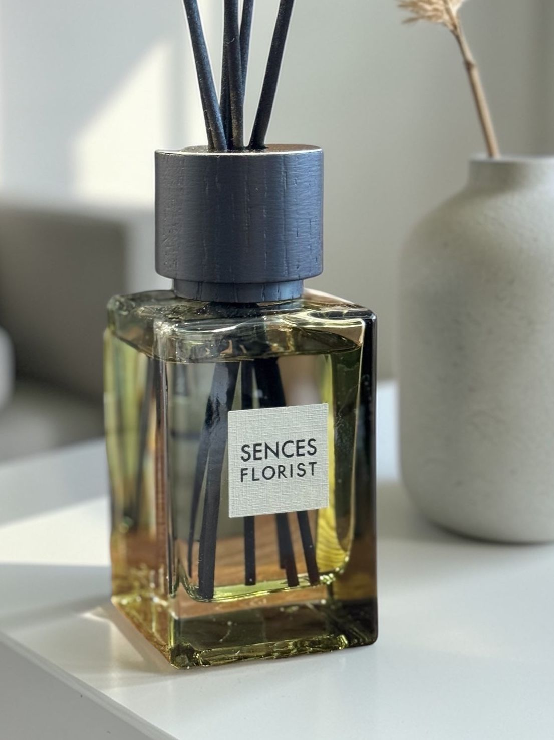 Olive green Coach House florist small reed diffuser for home fragrance with decorative reeds and sleek design.