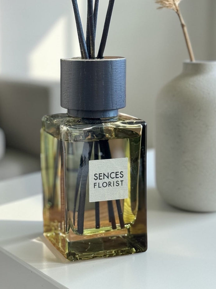 Olive green Coach House florist small reed diffuser for home fragrance with decorative reeds and sleek design.