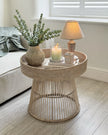 Lows rattan round side table with woven design, ideal for living room or patio decor, showcasing natural rattan material.