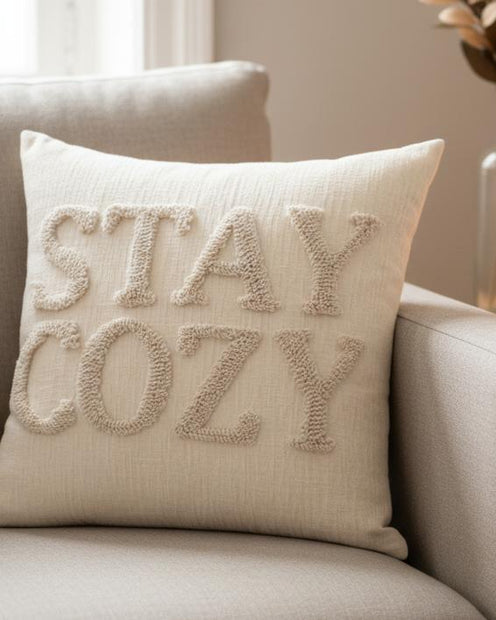 Stay Cozy Cream Cushion Cover, cream Stay Cozy cushion on an armchair