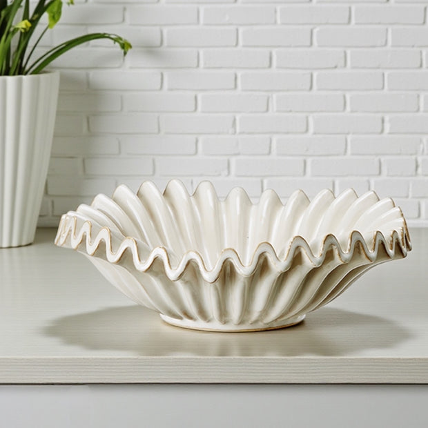 Neutral ceramic glazed ribbed wavy bowl by Wikholmform, showcasing its textured, flowing design suitable for home decor.