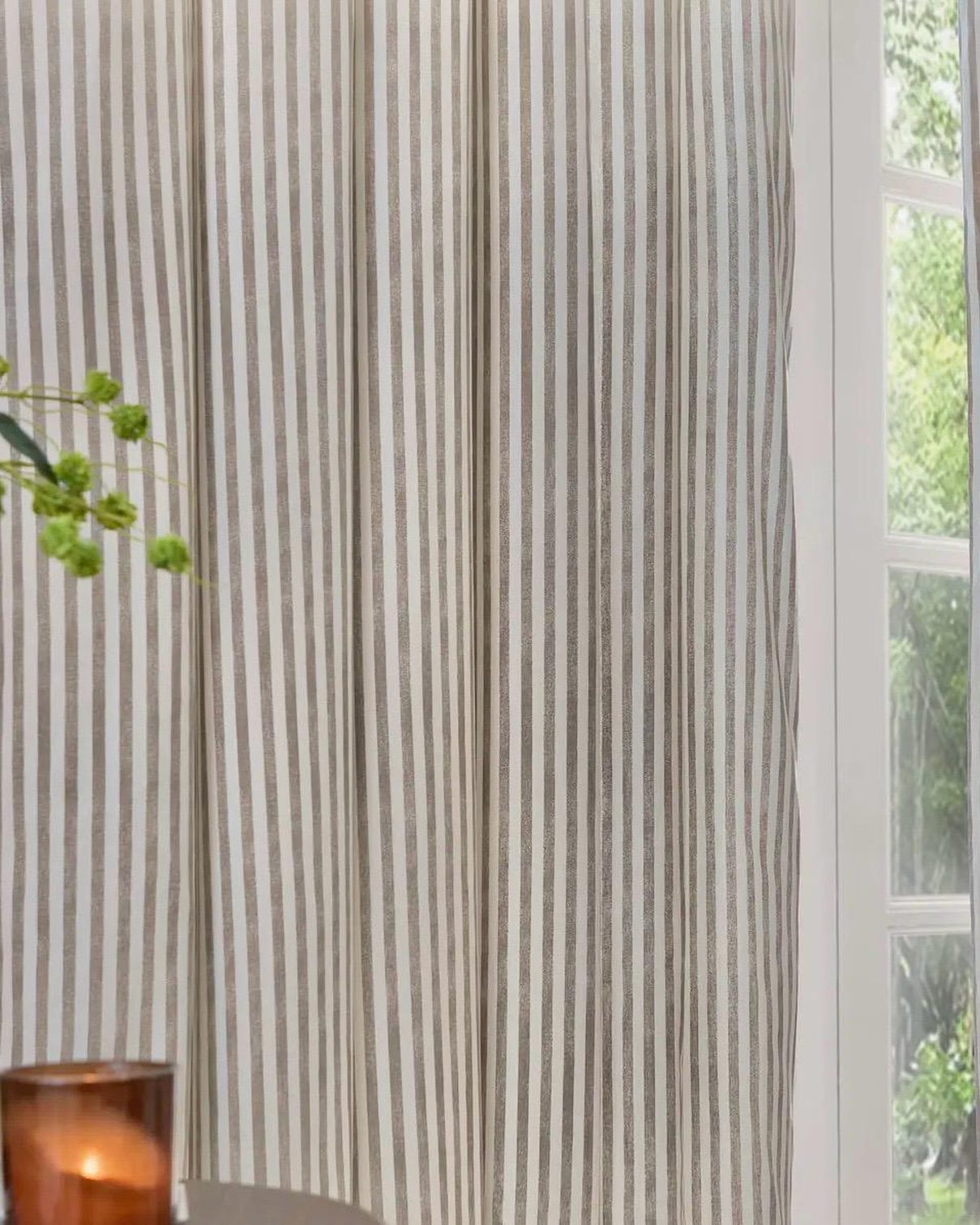 Black and white striped blackout eyelet curtains from Riva Home, soft furnishings for stylish window coverage.