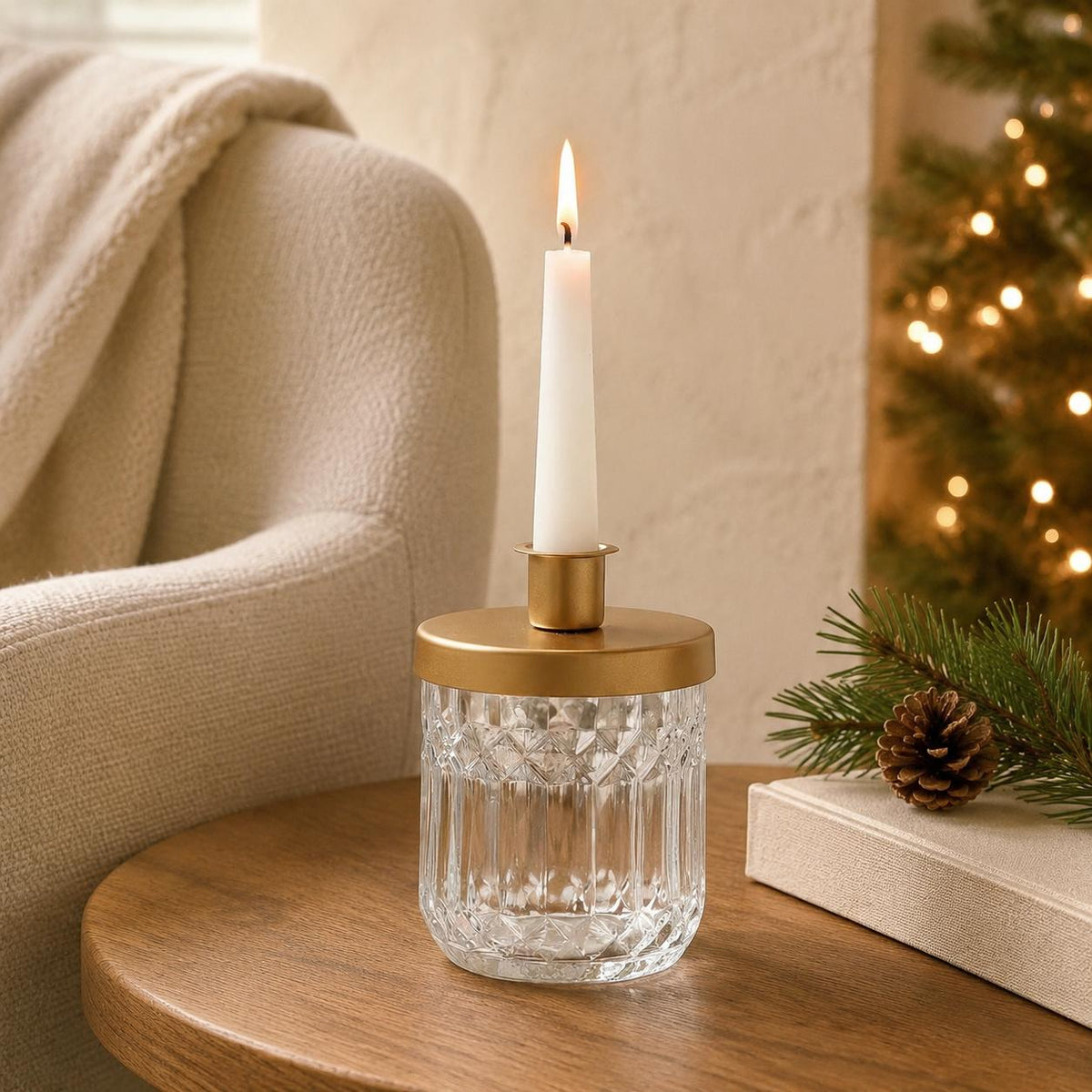 Brass And Glass Jar Candle Holder, clear patterned glass jar with brass lid holding a lit taper