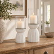 White Carved Hurricane Lantern, two white carved hurricane lanterns with candles on a console