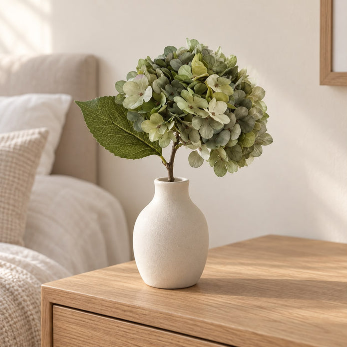 Artificial Short Sage Green Hydrangea Stem, sage green hydrangea in a cream vase on a wooden table
