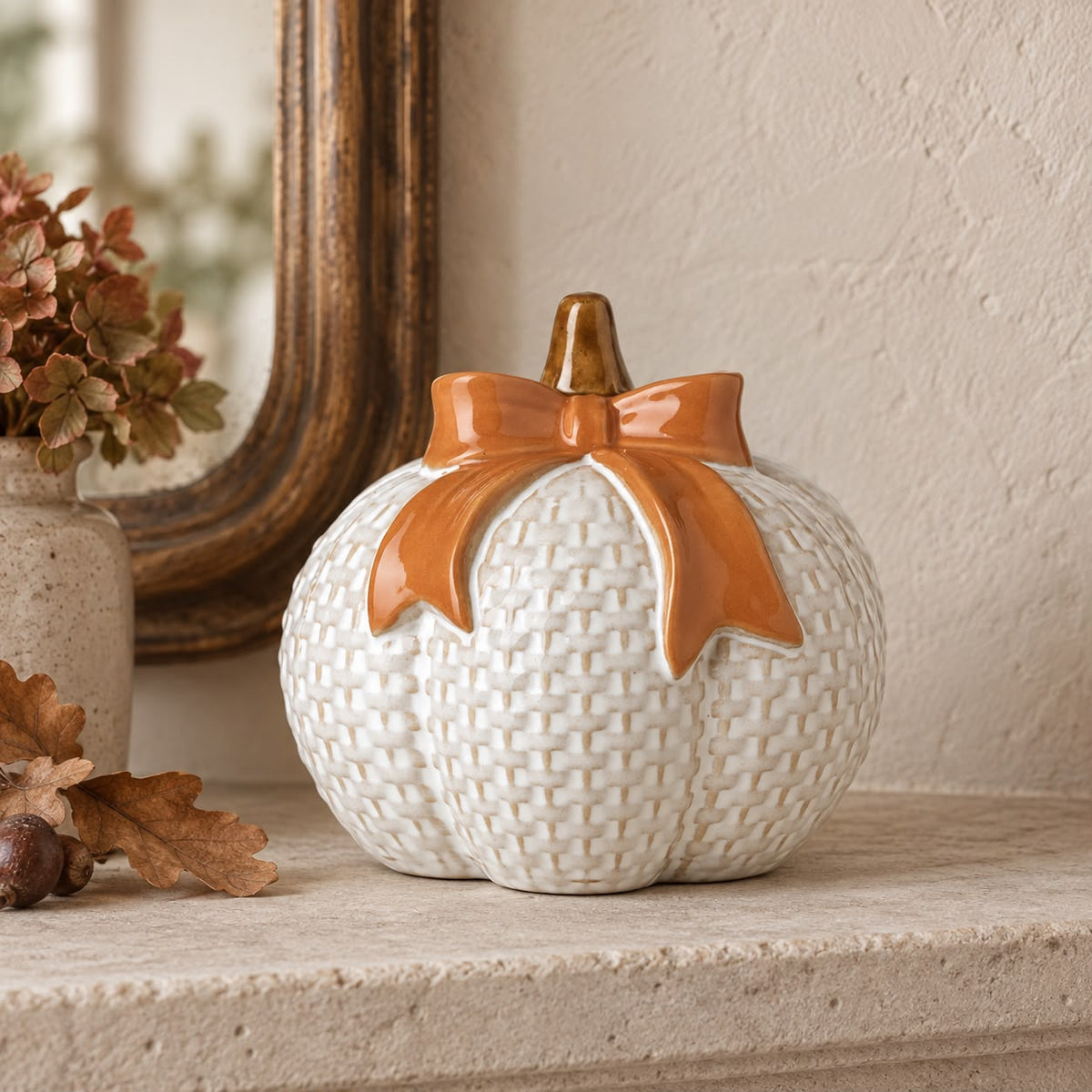 White ceramic pumpkin with orange bow, autumn decor by Heaven Sends, featuring a festive seasonal design.