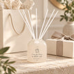 Beige Moments Clear Glass Reed Diffuser by Widdop & Co, home fragrance with reed sticks and decorative glass container.