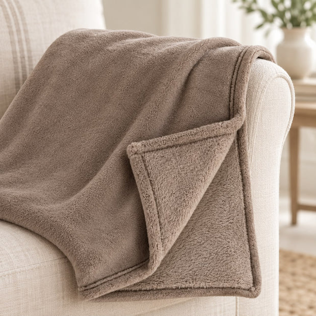 Beige Luxury Snuggle Blanket Throw, close-up of the beige throw and folded corner on a sofa arm