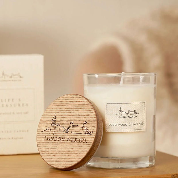 London Wax Company Lidded Candle - Cedarwood and Sea Salt, clear candle jar with engraved wooden lid beside its box