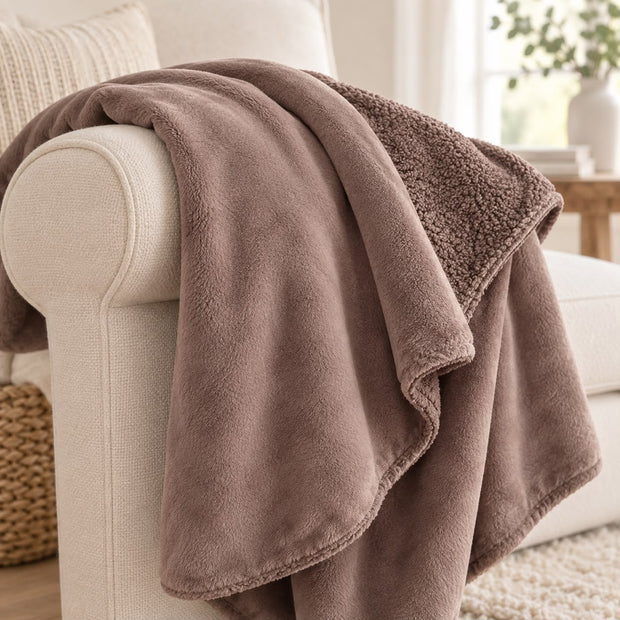 Coffee Brown Luxury Snuggle Blanket Throw, close-up of the coffee brown throw and textured reverse on a sofa arm