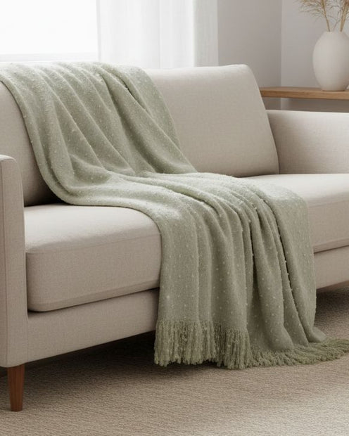 Green dotted faux mohair throw blanket by Malini, soft furnishings with a plush, dotted texture and cozy appearance.