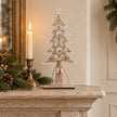 Wooden Tree With White Bells, wooden openwork tree with hanging bells on a mantel