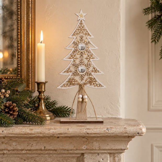 Wooden Tree With White Bells, wooden openwork tree with hanging bells on a mantel