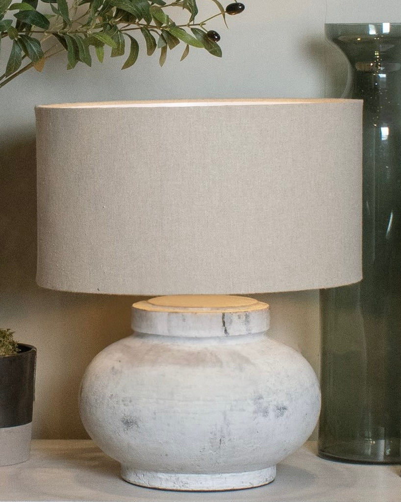 Hill Interiors Darcy squat round stone lamp with textured surface and modern lighting design.