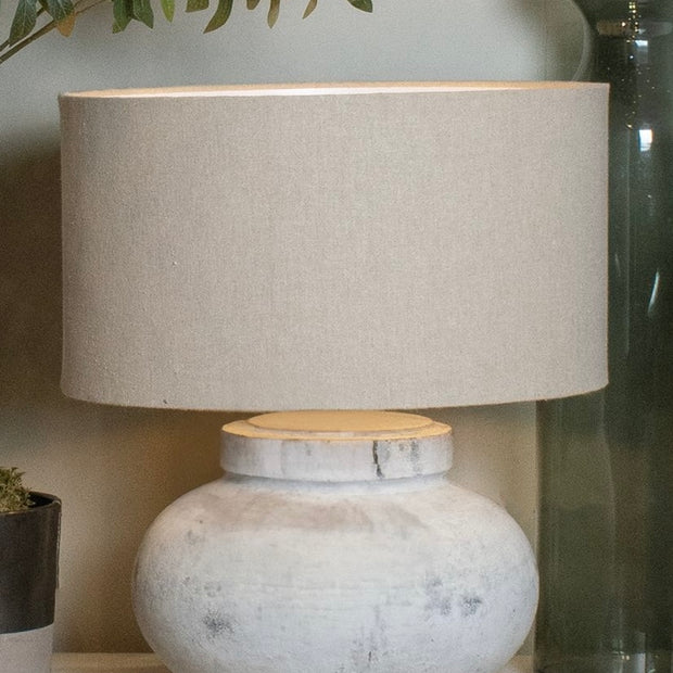 Hill Interiors Darcy squat round stone lamp with textured surface and modern lighting design.