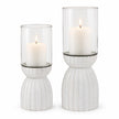 White Carved Hurricane Lantern, two white carved bases with clear glass candle sleeves against white