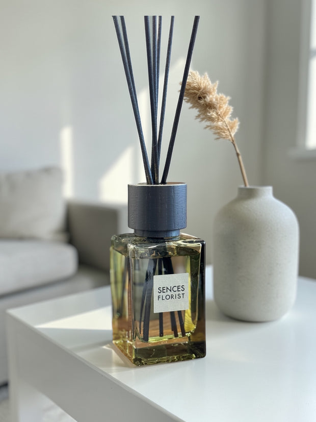 Olive green Coach House florist small reed diffuser for home fragrance with natural reed sticks and decorative glass bottle.