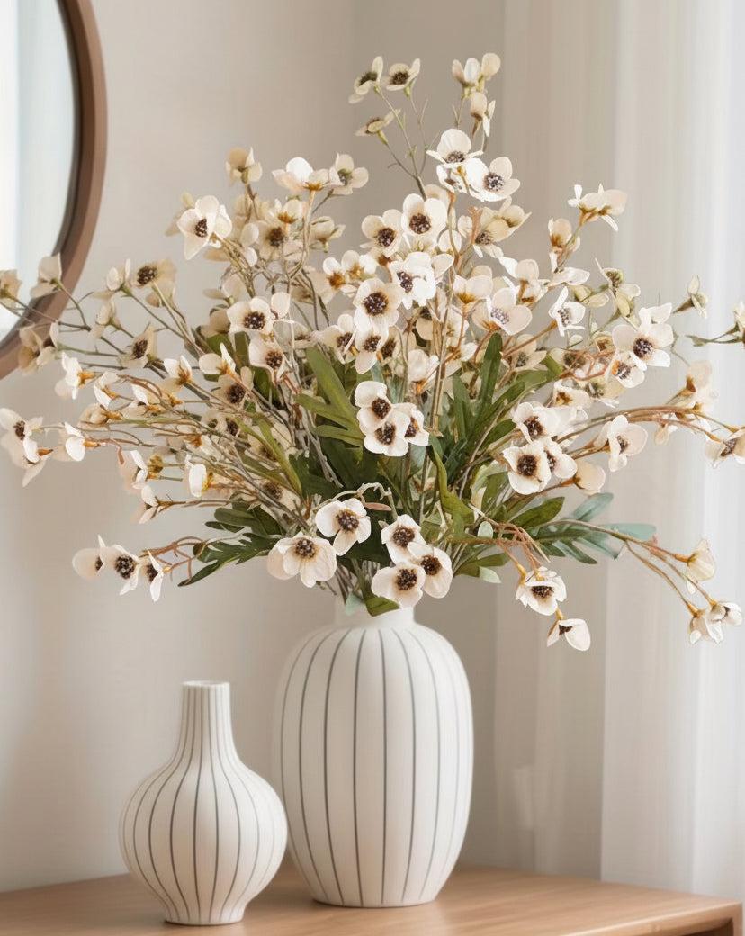 Cream artificial daisy flower stem from Starlight Express, with realistic white petals and green foliage on a slender stem.