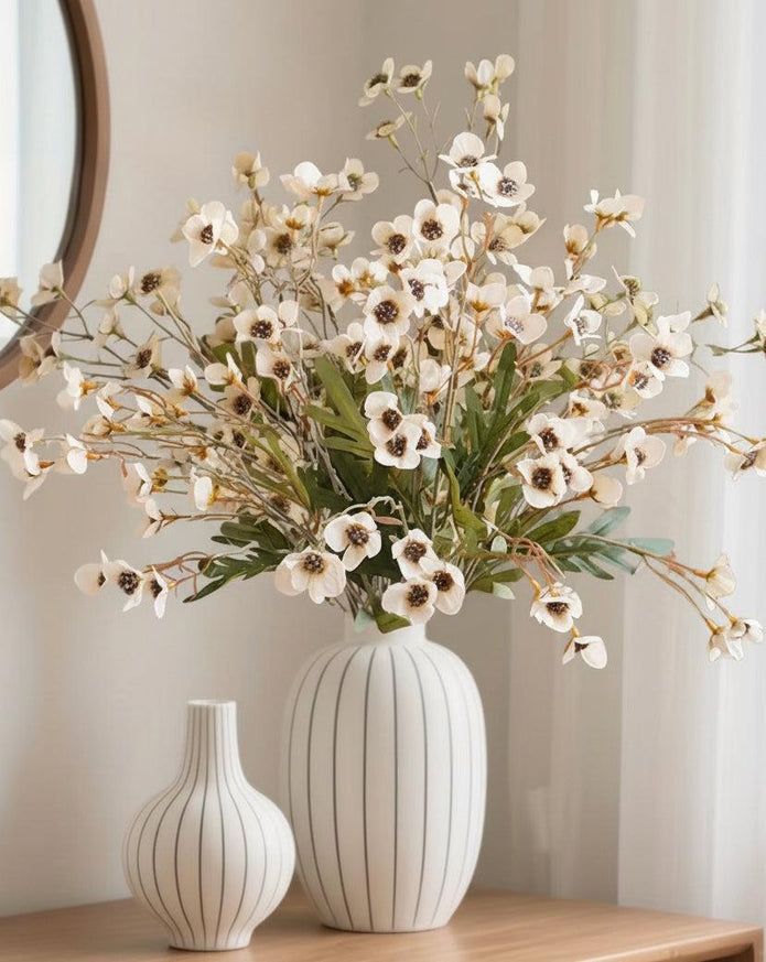 Cream artificial daisy flower stem from Starlight Express, with realistic white petals and green foliage on a slender stem.