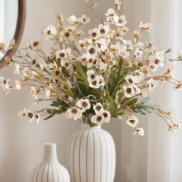 Cream artificial daisy flower stem from Starlight Express, with realistic white petals and green foliage on a slender stem.
