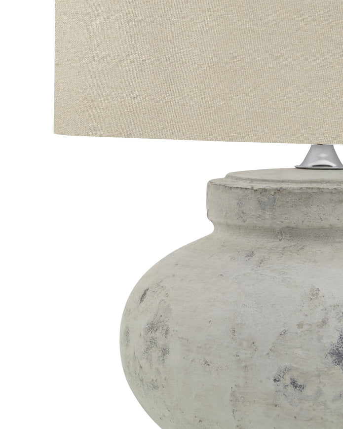 Round stone lamp with squat design by Hill Interiors, featuring a textured surface and modern lighting aesthetic.