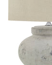Round stone lamp with squat design by Hill Interiors, featuring a textured surface and modern lighting aesthetic.