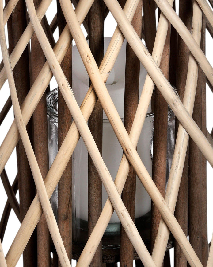 Natural rattan wicker bulbous garden candle lantern for home decor, featuring a woven design and glass interior holder.