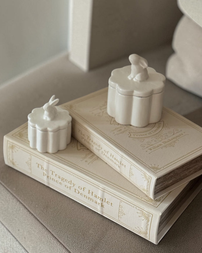 Set of two vintage cream and gold Coach House storage book boxes with elegant design, perfect for home decor organization.