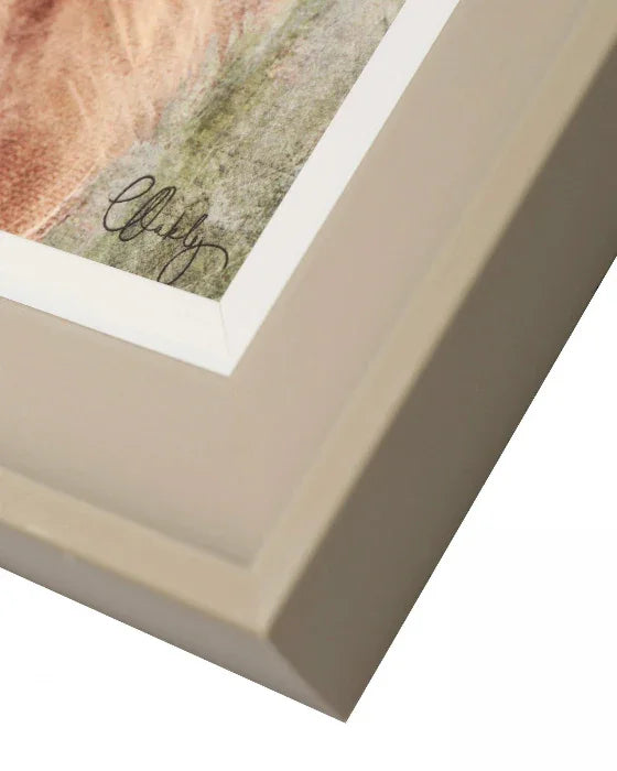 Close-up of a framed photograph with a signature on a white background