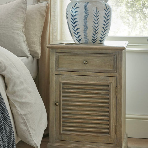 Hill Interiors Delphine Collection bedside table with one drawer and one door, showcasing a sleek wooden finish and modern design.