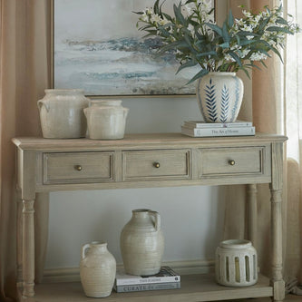 Delphine Collection 3 Drawer Console with Shelf by Hill Interiors, showcasing a sleek wooden furniture piece with drawers and a top shelf.