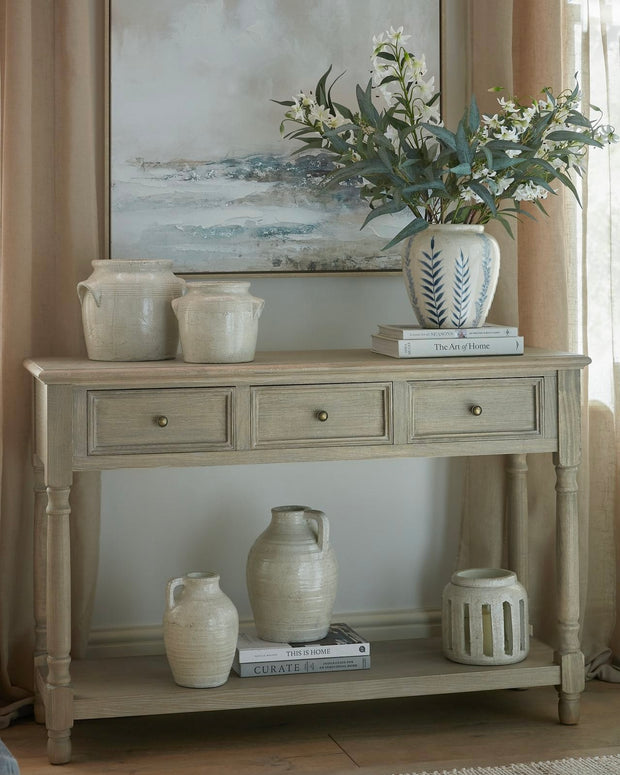 Delphine Collection 3-drawer console table with shelf by Hill Interiors, showcasing a modern wooden furniture piece with sleek design.