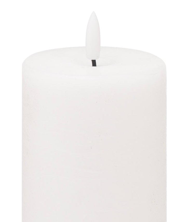 White LED Light Up Pillar Candle from Hill Interiors, showing a glowing, flickering candle with a realistic wax finish and textured surface.