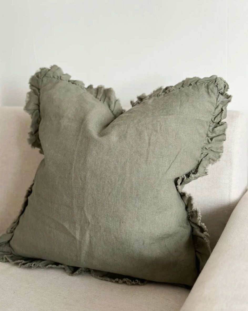 Olive green square linen cushion cover with ruffled edges, soft furnishings by Ellenvale Trade, shown on a neutral background.