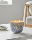 Navy blue two-wick ceramic candle from Heaven Sends, featuring a smooth, glossy finish and two lit wicks for ambient lighting.